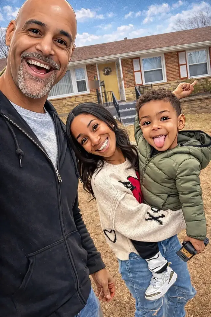 Henry Owens and his family in front of a St. Louis home